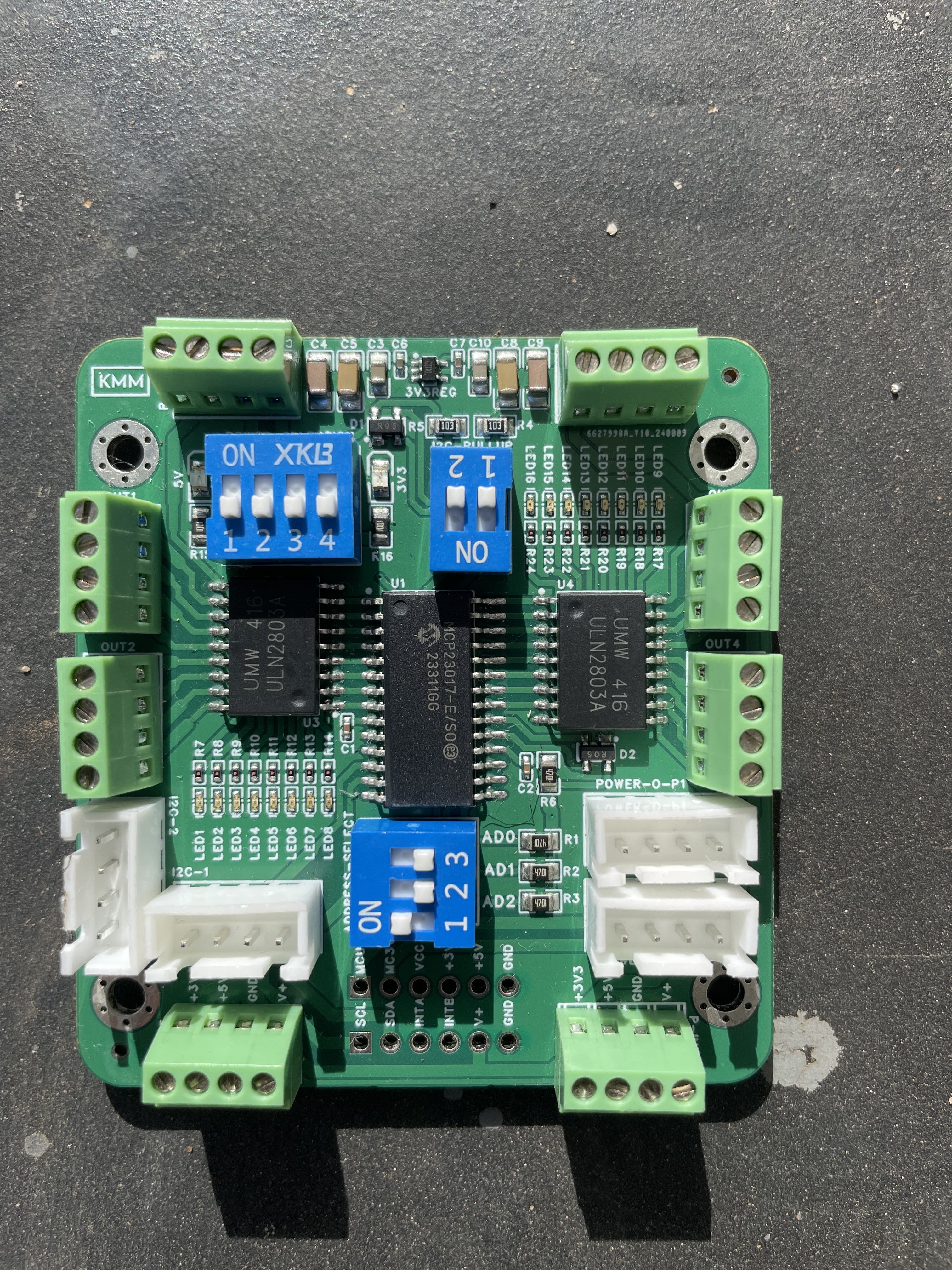 16-channel digital output module — shift register ICs, DIP address switches, and mixed JST/screw terminal outputs